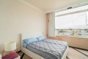 a bedroom with a bed and a large window at The Lodge Salento - San Foca in San Foca