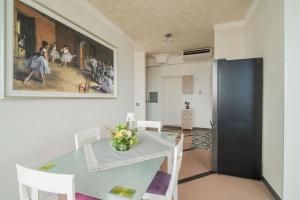 a dining room with a table and a painting on the wall at The Lodge Salento - San Foca in San Foca +267 photos