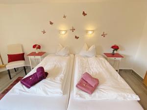 two beds in a room with white sheets and purple pillows at EL MOLINO - ehemalige Mühle mit großem Gartenareal in Modlisch +31 photos