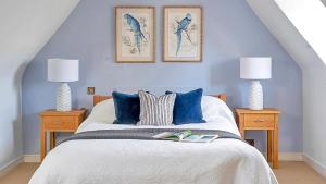 a bedroom with a bed with blue walls and two lamps at Finest Retreats - Tormarton Court in Tormarton +35 photos