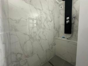 ein Bad mit einer weißen Marmorwand in der Unterkunft Appartement de la mer in Le Gosier + 17 Fotos