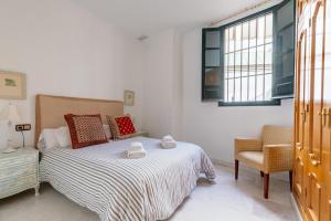 Postel nebo postele na pokoji v ubytování GY Apartamento en Casa Sevillana junto a las Setas