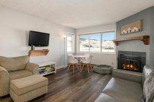 a living room with a couch and a fireplace at Summit Unit 1103 in Granby