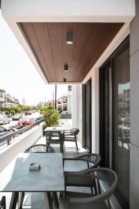 a patio with tables and chairs on a balcony at PREVEZA VILLA center in Preveza