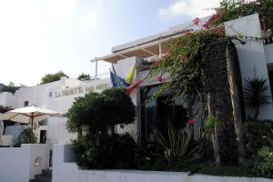 a white building with plants on the side of it at La Sirenetta Park Hotel in Stromboli