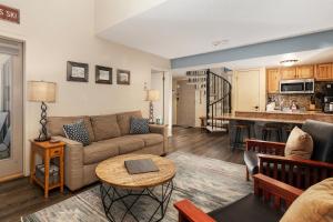 a living room with a couch and a table at Summit Unit 1303 in Granby
