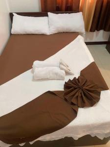a bed with towels and a bow on it at The Birrells Boracay by Cassy in Boracay +10 photos