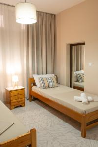 a bedroom with a large bed and a mirror at Ifigenia sea view in Artemida +45 photos