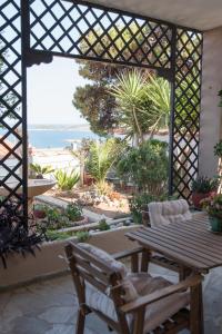 a patio with a table and a view of the beach at Ifigenia sea view in Artemida