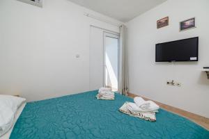 Postel nebo postele na pokoji v ubytování Apartments Tasa