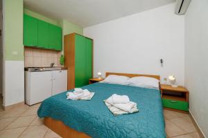 Postel nebo postele na pokoji v ubytování Apartments Tasa