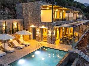 a house with a swimming pool in front of it at Azzura villas in Vasiliki