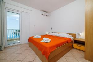 Postel nebo postele na pokoji v ubytování Apartments Tasa