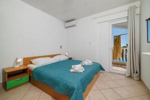 Postel nebo postele na pokoji v ubytování Apartments Tasa