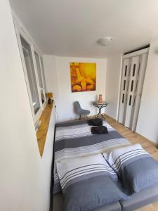 a bedroom with a bed and a chair at Maison au coeur de Banon in Banon