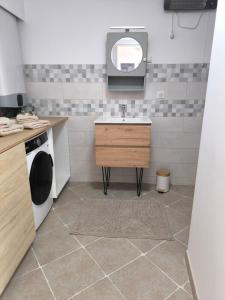 a kitchen with a sink and a washing machine at Maison au coeur de Banon in Banon +9 photos