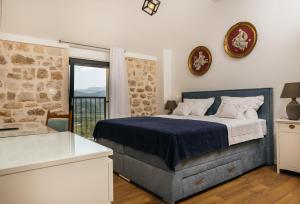 a bedroom with a large bed and a window at Vila Đirada in Imotski