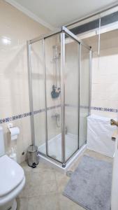a bathroom with a shower with a toilet and a sink at Tróia 2 Minutes from the Beach in Troia +26 photos