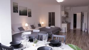 a room with a bed and a table with chairs at MIRA apartments in Prague