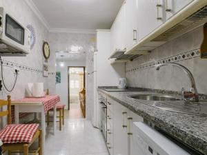una cucina con un lavello e un piano di lavoro di Cubo's Casa Rural El descanso del Caminito del Rey ad Ardales
