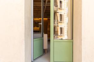 a glass door to a window in a building at Decô Apartments Barcelona-Born St. in Barcelona
