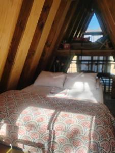 a bedroom with a bed in a attic at Lodge Rincon Nativo in Hijuelas