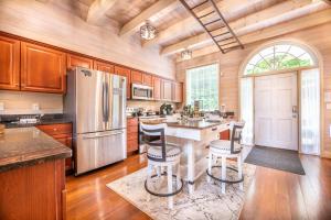 a kitchen with a refrigerator and a table with chairs at Mountain View Hideaway By Avada Properties in Sevierville