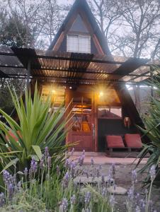 a small house with a thatched roof at Lodge Rincon Nativo in Hijuelas