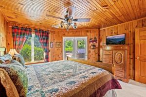 a bedroom with a bed and a ceiling fan at Mountains 4 Miles By Avada Properties in Gatlinburg
