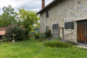 an old brick building with a grass yard at Cá Pradella - Harmony and Nature, Bed & Breakfast in Monterenzio +14 photos