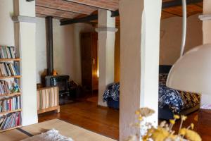 a living room with a bed and a fireplace at Cá Pradella - Harmony and Nature, Bed & Breakfast in Monterenzio