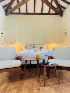 a living room with couches and a table at Oryza Guest House& Suites in Coimbra