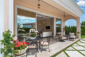 an outdoor patio with a table and chairs at Villa Dolce Vita in Sunny Beach