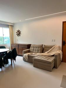 a living room with a couch and a table at Flat 505 Condomínio Topo da Montanha in Chã Grande