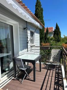 a table and two chairs on a deck at Studio bord de mer 1 lit double 1 lit simple in Hyères