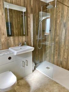 a bathroom with a shower and a toilet and a sink at Springwood Room Only Accommodation in Seahouses +17 photos