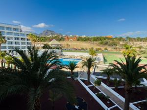 a view of a resort with palm trees and a pool at Piso los Agaves in Costa de Adeje