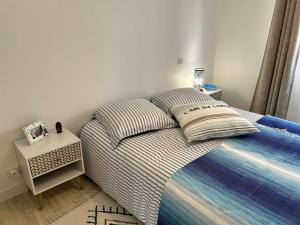 a bed with two pillows on it in a bedroom at 669 - Maison 4 personnes en centre bourg d'Erquy in Erquy