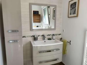 a bathroom with a sink and a mirror at 669 - Maison 4 personnes en centre bourg d'Erquy in Erquy