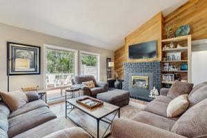 a living room with a couch and a fireplace at 8 Dixie Mountain Lane in Sunriver