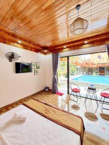 a bedroom with a large bed and a pool at Trang An Hana homestay in Nguyên Ngoại