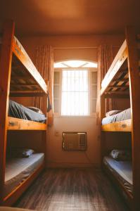 a room with two bunk beds and a window at LiveRio Hostel Ipanema in Rio de Janeiro