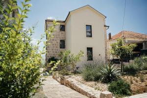 a house with a garden in front of it at Vila Đirada in Imotski