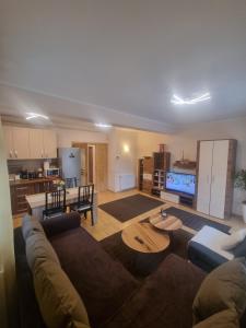 a living room with a couch and a table at Apartament Kalinderu K4 Busteni in Buşteni