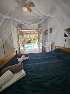 a bedroom with two beds in a tent at private Villa mit eigenem Pool unter Palmen in Cala Llenya +30 photos
