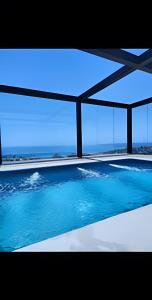 a large swimming pool with a view of the ocean at 505 ,Depto studio NUEVO!, Boutique in Viña del Mar