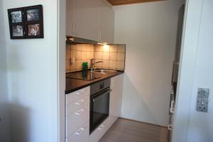 a small kitchen with a sink and a stove at Svendsgade 80 ground floor door 2 id 78 in Esbjerg
