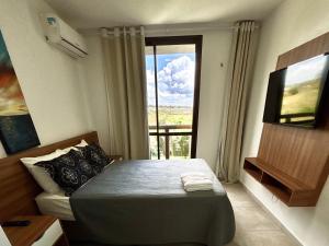 a bedroom with a bed and a large window at Condomínio Wai Wai Pé na Areia - Praia de Cumbuco in Cumbuco +65 photos