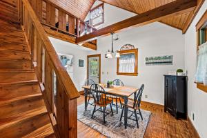 a dining room with a table and chairs and wooden ceilings at Bear Tracks Lodge By Avada Properties in Sevierville