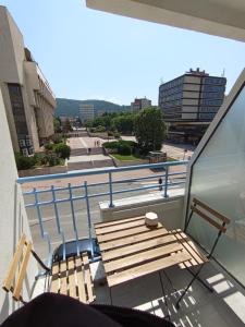 a balcony with a bench and a view of a street at Уютно Студио Verde Suites 07 in Blagoevgrad